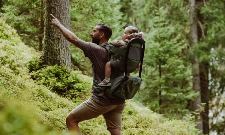 Man med barn i bärstol